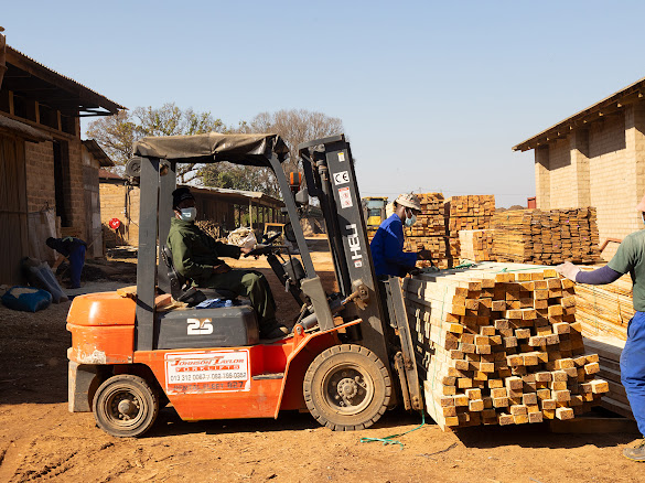 Forklift moving treated garden timber for dispatch